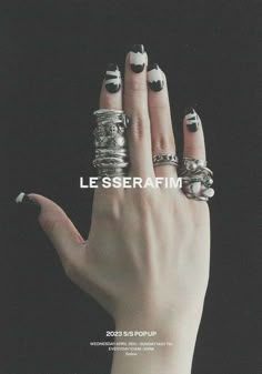 a woman's hand with rings on it and the words les serafim