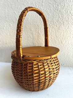 a wicker basket sitting on top of a white table