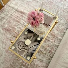 pink roses are sitting on top of a mirrored tray