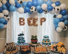 a table topped with lots of desserts and balloons