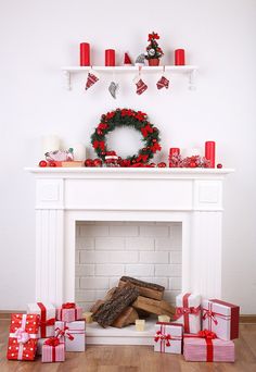 a christmas fireplace with presents and wreath on top