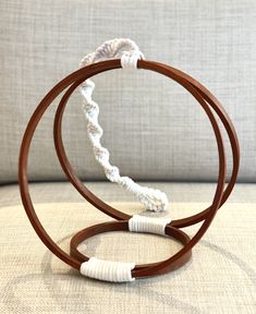 two wooden and white bracelets sitting on top of a couch