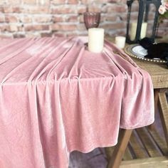 a pink table cloth on top of a wooden table