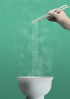 a hand holding chopsticks over a toilet bowl with the words written on it