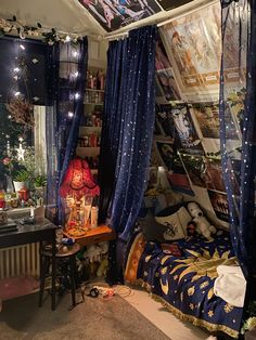 a bedroom with blue curtains and pictures on the walls, lights in the ceiling and decorations all over the room