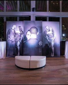 a couch sitting in front of three large pictures on the wall at a wedding reception