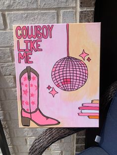 a painting that says cowboy like me with boots and a disco ball in the background