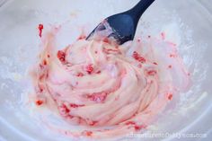 a spoon in a bowl filled with ice cream