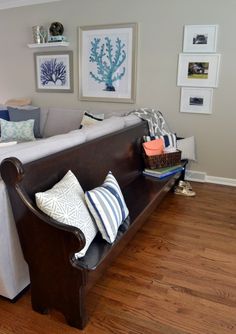 a living room filled with furniture and pillows on top of a hard wood floored floor