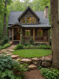 a log cabin in the woods with stone steps leading up to it's front door