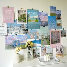 a white desk topped with pictures and vases filled with flowers on top of it