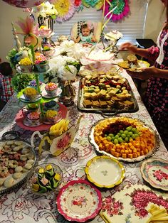 a table filled with lots of food and desserts