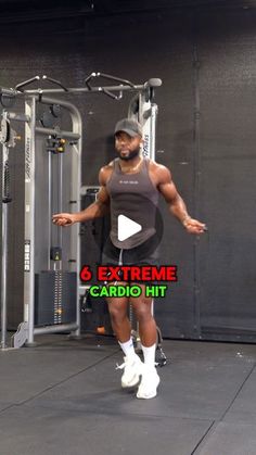 a man standing in front of a gym machine with his arms out and legs apart