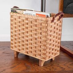 a wooden table with a basket on top of it and a magazine holder in the middle