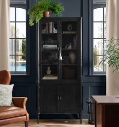 a living room scene with focus on the bookcase and chair in the foreground