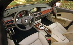 the interior of a bmw car with leather seats and dashboard controls, including steering wheel