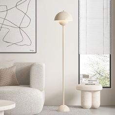 a living room with a white couch and floor lamp