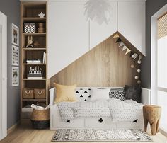 a white bed sitting in a bedroom next to a wooden book shelf filled with books