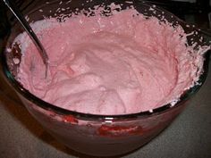 a large bowl filled with pink cake batter