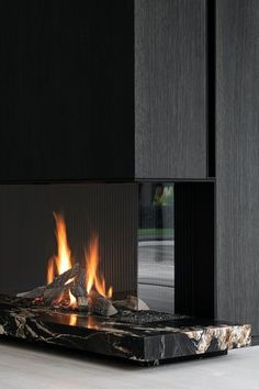 a modern fireplace with flames burning in it