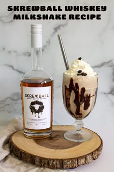 an ice cream sundae with chocolate syrup and whipped cream in a glass next to it