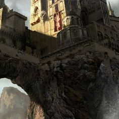 a castle on top of a cliff with water crashing around it and mountains in the background