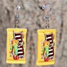 a pair of earrings with candy bars on them