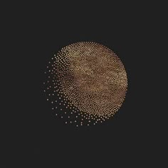 a black background with gold dots in the shape of a circle on top of it