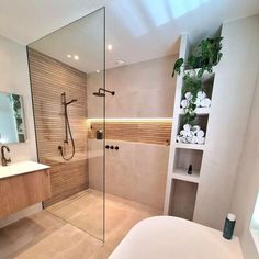 a bathroom with a glass shower door, sink and toilet next to a bathtub