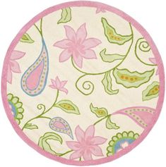 a round rug with pink and green flowers on it