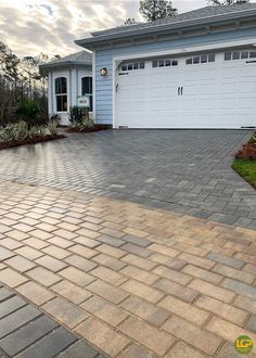 a house with a driveway in front of it and a garage on the other side