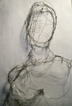 a drawing of a person's head and body with wires on the wall behind it