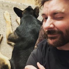 a man standing in front of two dogs