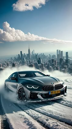 a bmw concept car driving through the snow in front of a large cityscape