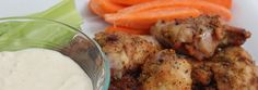 chicken wings with ranch dressing and carrots on the side