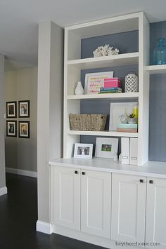 a white book shelf with pictures on it