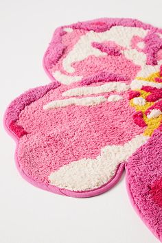 two pink rugs sitting on top of a white table