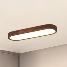 a wooden light fixture is mounted on the ceiling