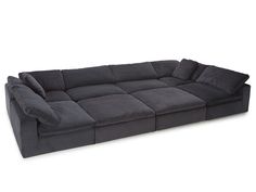 a large gray couch sitting on top of a white floor