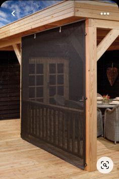 a covered patio area with chairs and tables