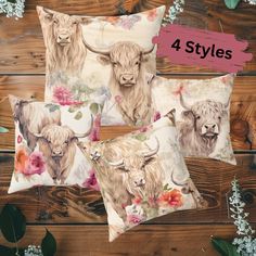 four pillow cases with longhorns and flowers on them, sitting on a wooden surface