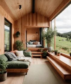 a living room filled with furniture and lots of wood on the walls next to a large window