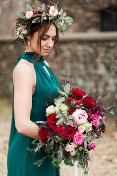 a woman in a green dress holding a bouquet