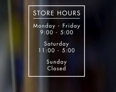 a store hours sign on the glass door