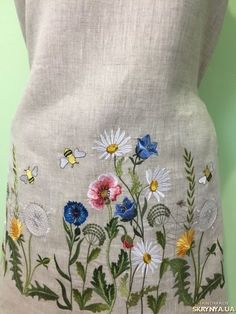 an embroidered dress with flowers and butterflies on it