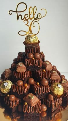 there is a cake made to look like a tree with lots of chocolates on top