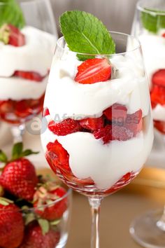 strawberries and whipped cream in wine glasses