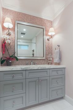 a bathroom vanity with two sinks and a large mirror