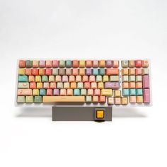 a computer keyboard with multicolored keys on it