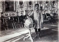 an old black and white photo of a man holding a large vase in his hand